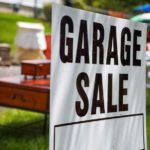 garage sale sign on a lawn