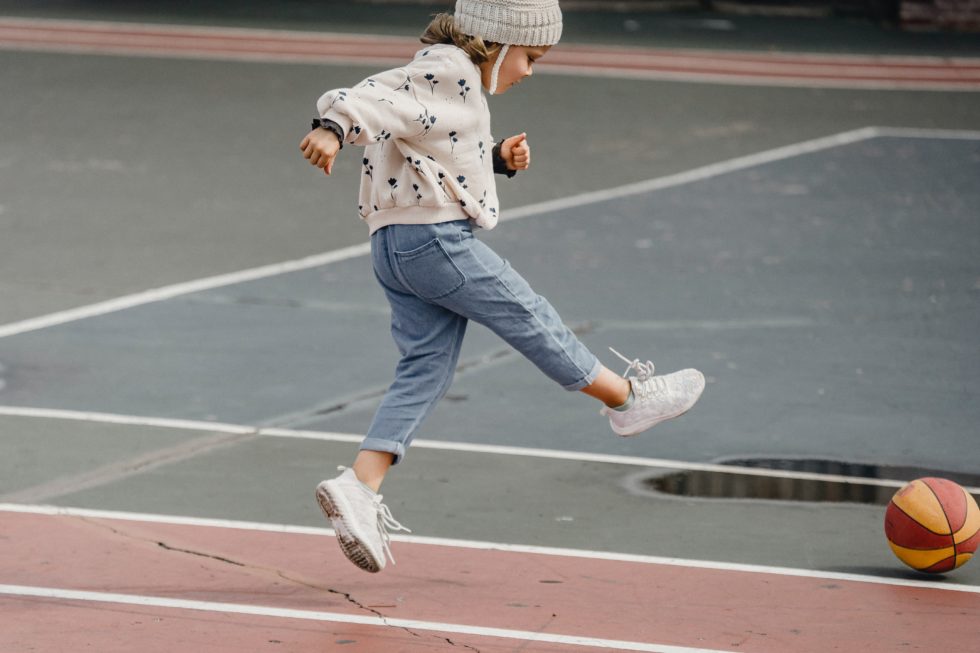 child kicking a ball